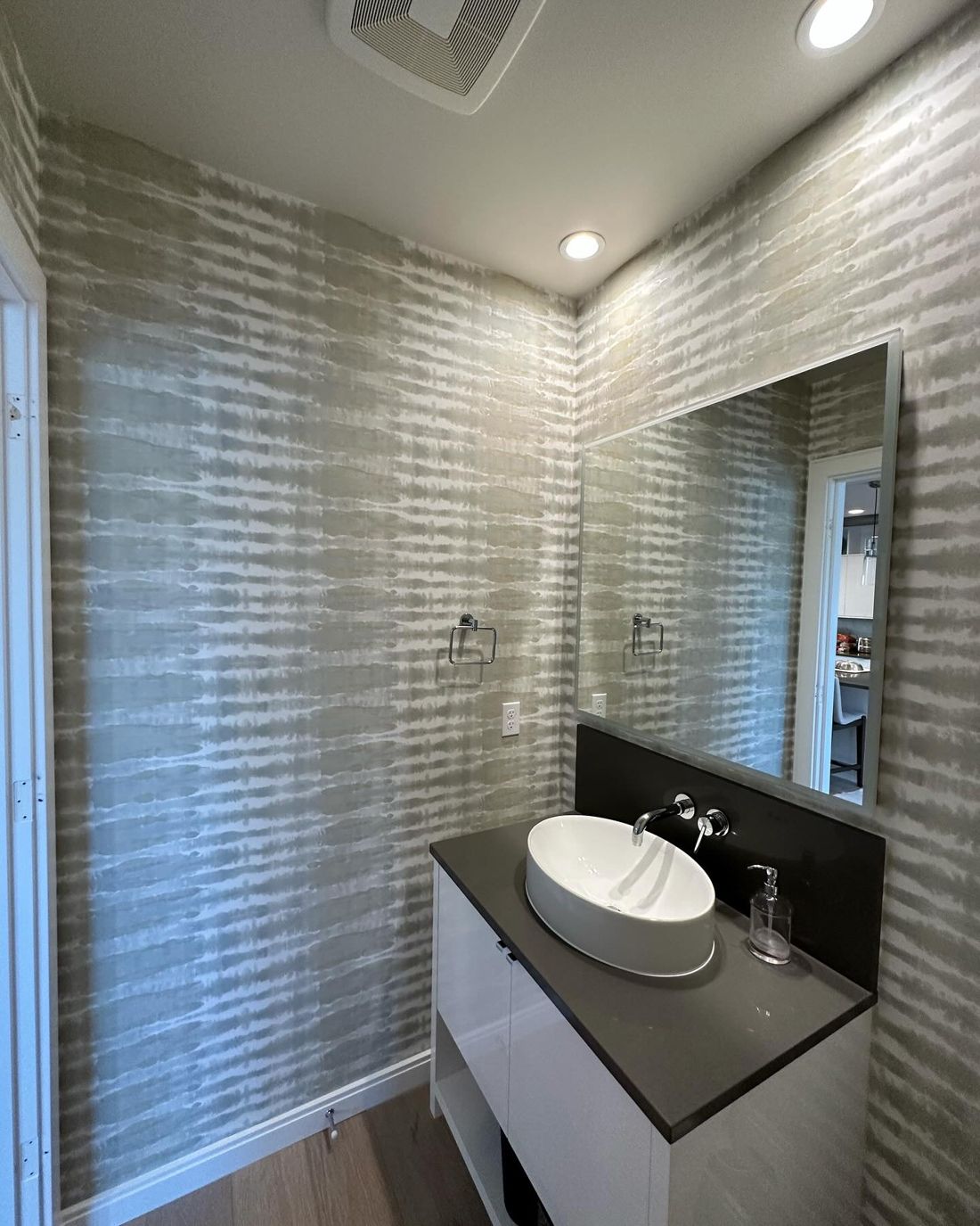 Modern powder room with grey brush-stripe wallpaper