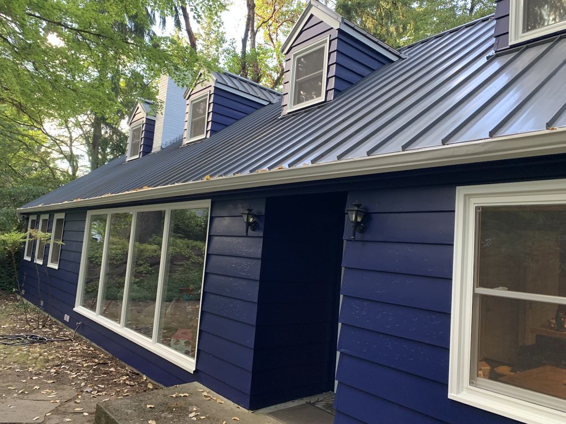 House exterior repainted navy with white trim